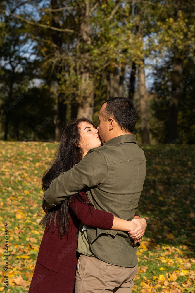 Beautiful young couple in autumn forest on a sunny day