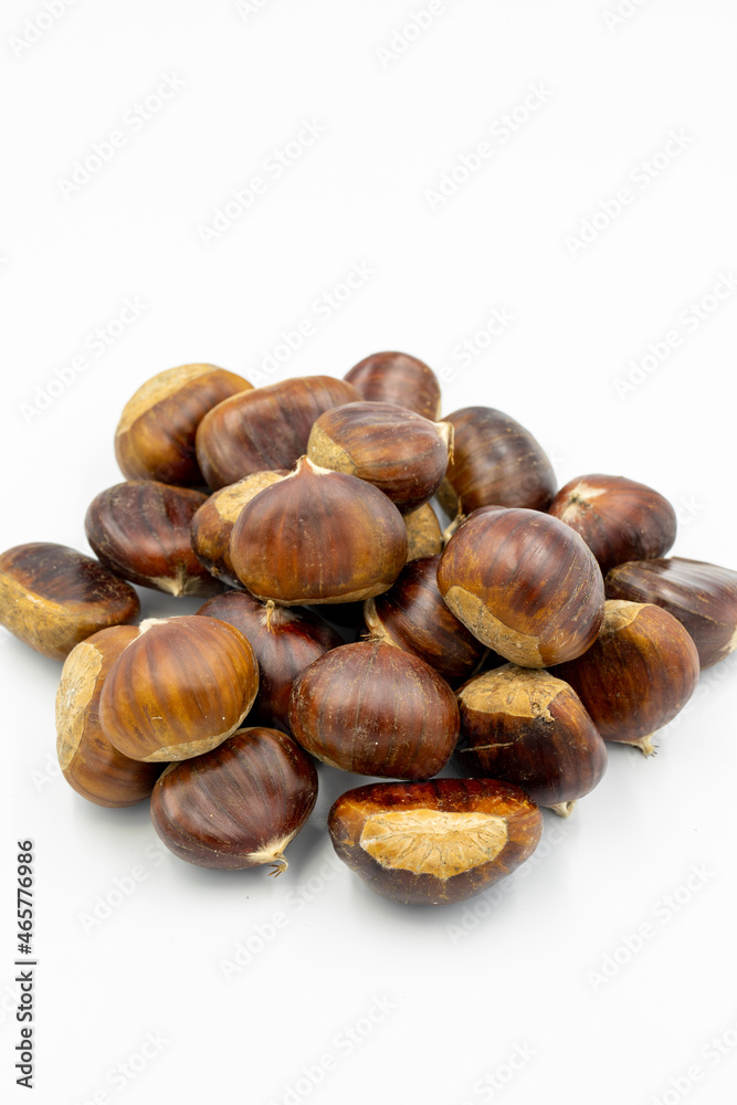 Organic chestnuts on a white background with shadow. close up Organic chestnuts on a white background with shadow. close up