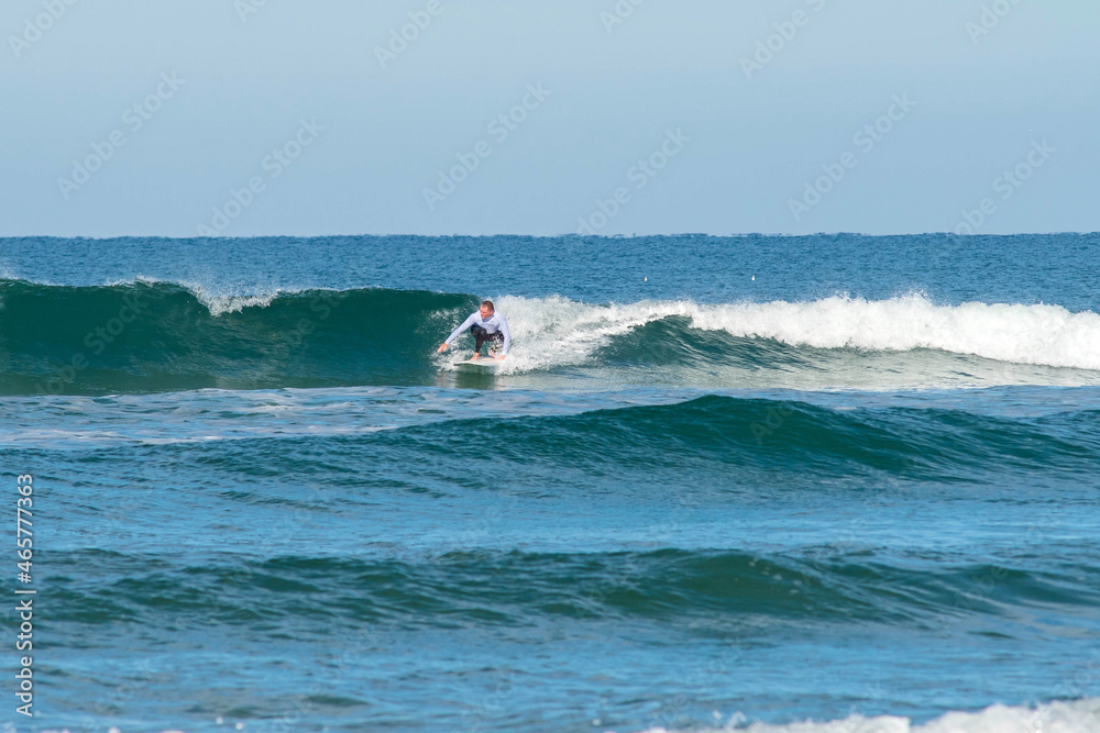senior surfer in action in small waves