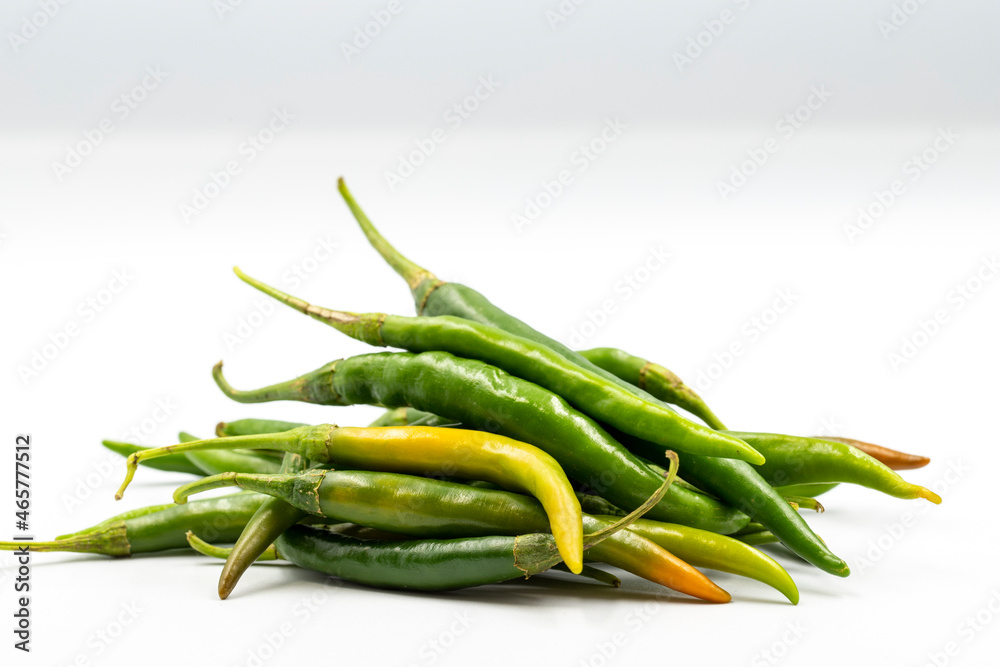 Green chili peppers on white background with shadow. close up Green chili peppers on white background with shadow. close up