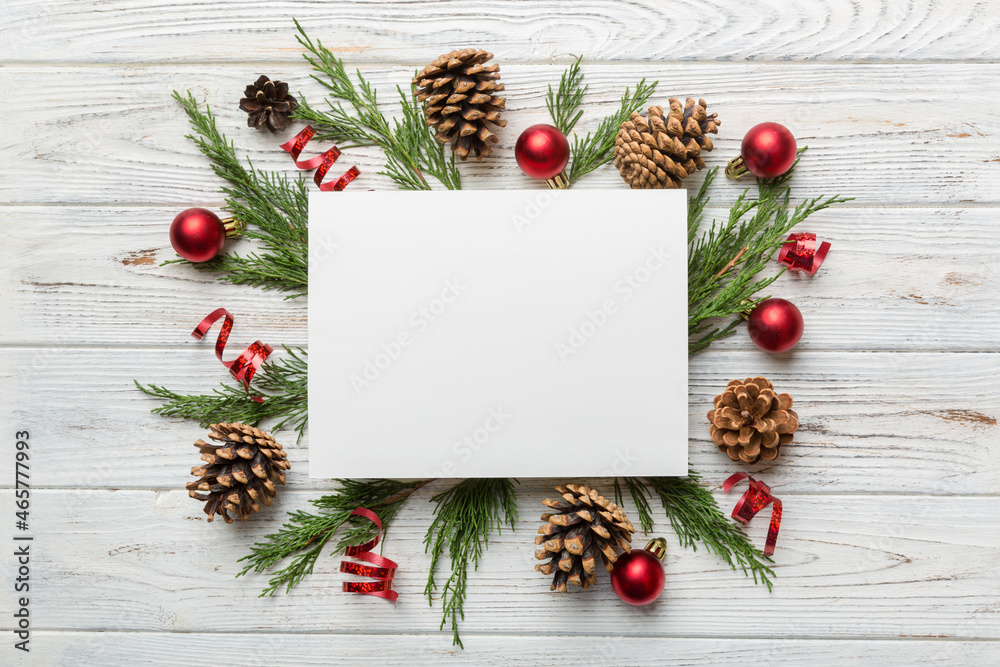 Flat lay Christmas composition. square Paper blank, pine tree branches, christmas decorations on Colored background. Top view, copy space for text Flat lay Christmas composition. square Paper blank, pine tree branches, christmas decorations on Colored background. Top view, copy space for text