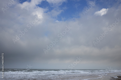 Clouds. Blue sky. Waves sea. Julianadorp coast Netherlands. Northsea.