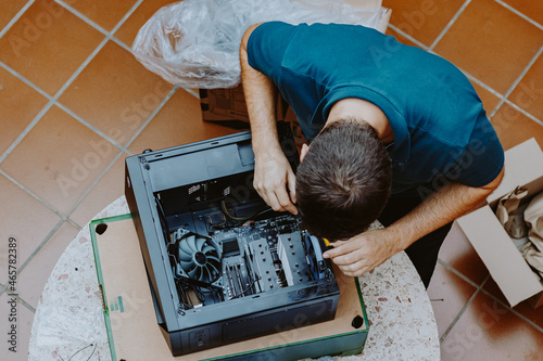 Technician repair assembles computer at home. Computer repair, assembling a personal computer. Working from home. Technology background. Pc build. Installing Hardware components.