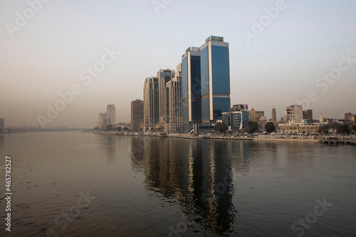 reflection of modern buildings in the Nile of Cairo Egypt