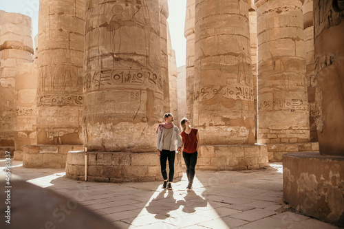 Traveling couple walking through Karnak temple in Luxor Egypt 