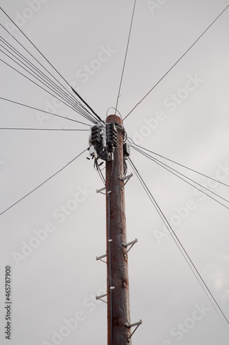 Telegraph pole with wires branching out to local homes