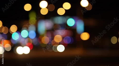 Soft focus lights moving in a night time city setting