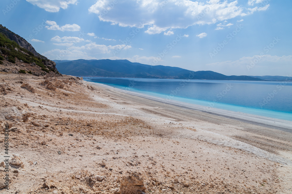 Fototapeta premium Lake Salda, Turkey. A popular place for recreation and tourism. White sand and blue water. Natural background