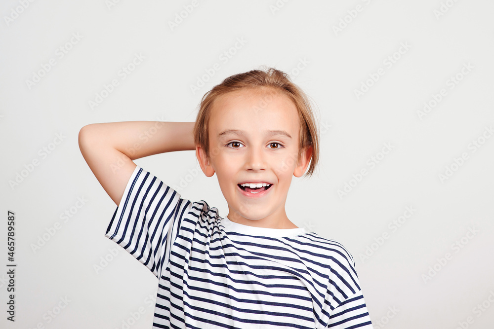 Smiling boy posing at studio. Face expression. Portrait of funny boy. Kid having fun and laughing. Smiling boy posing at studio. Face expression. Portrait of funny boy. Kid having fun and laughing.