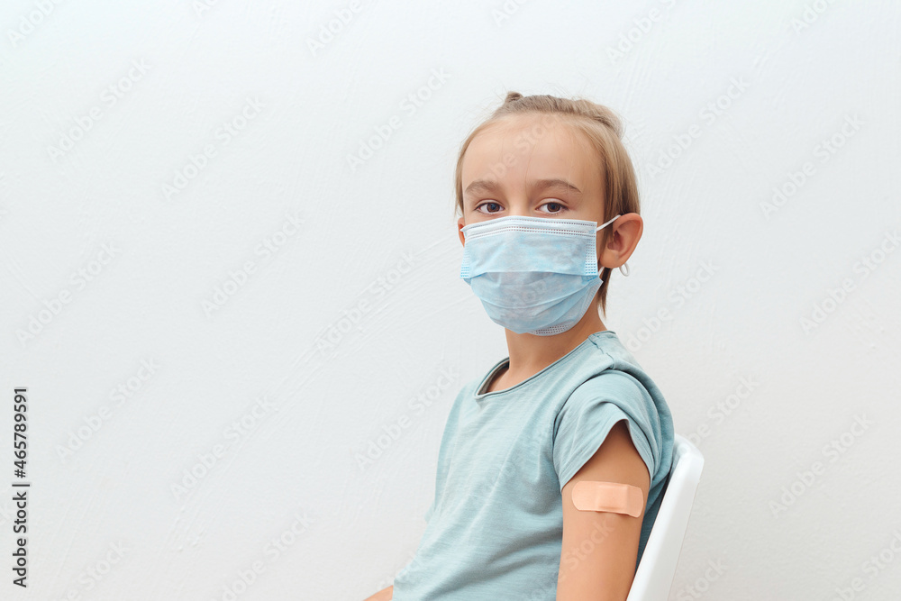 Boy vaccinated against coronavirus infection. Child wearing protective mask.