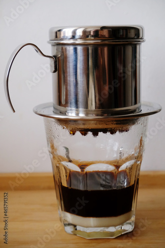 Making coffee in a Vietnamese phin with condensed milk in a glass