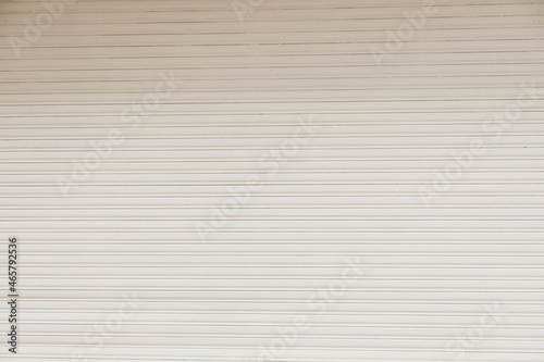 White metal curtain mockup - business closed with white grunge metal roller shutter door