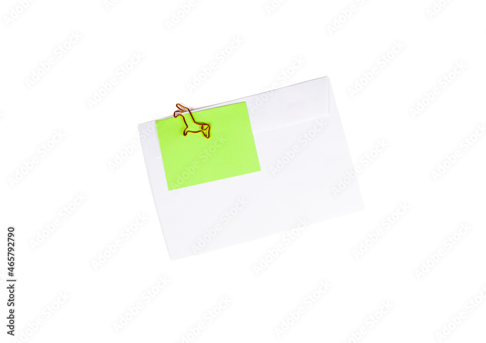 Paper envelope with blank note and dog-shaped paper clip on white background. Office supplies for a good mood. reminder on paper. Paper envelope with blank note and dog-shaped paper clip on white background. Office supplies for a good mood. reminder on paper.