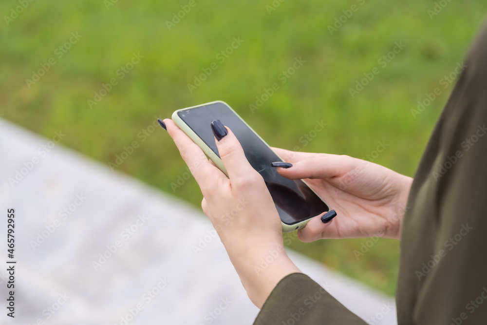 Hands of an unrecognizable person with a mobile phone in hand