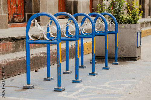 Empty bicycle parking in colonial city - signs to park bicycles in the city center