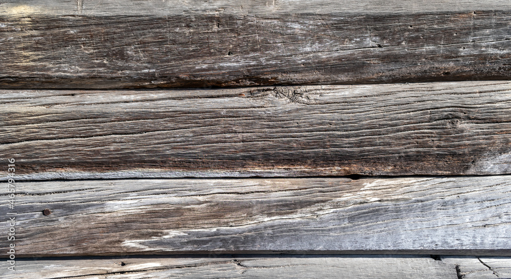 Background from old wooden boards with an interesting texture. Textured wood pattern. Photos of boards fitted to each other. Background from old wooden boards with an interesting texture. Textured wood pattern. Photos of boards fitted to each other.