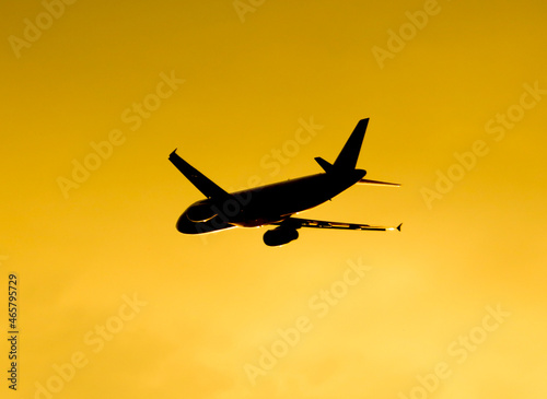 Silhouette of an airplane at sunset.