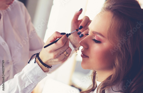 beautiful young model woman getting fashion make-up