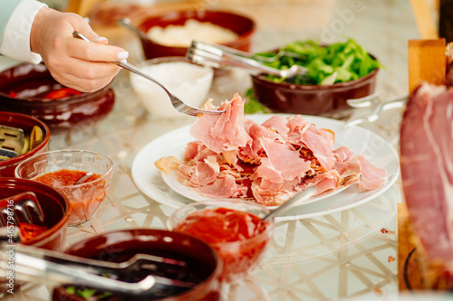 a person puts pieces of dried meat in a plate