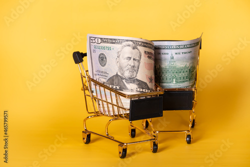 American banknotes dollars in a shopping cart. Shopping, discounts.