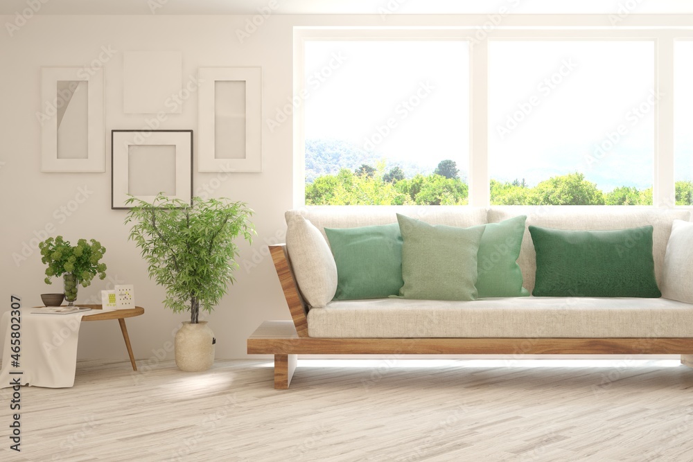 Fototapeta premium White living room with sofa and summer landscape in window. Scandinavian interior design. 3D illustration