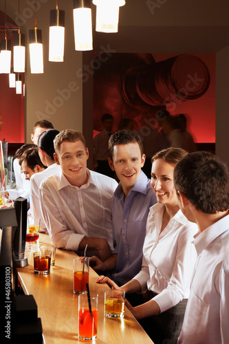 Coworkers enjoying drinks at bar after work