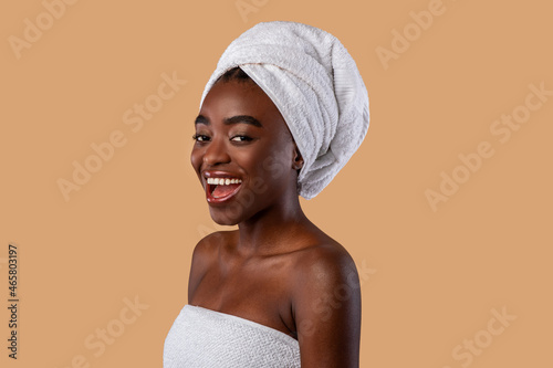 Portrait of beautiful young black woman laughing at studio