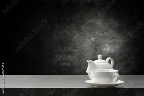 Dark tea pot on desk and free space for your decoration. 