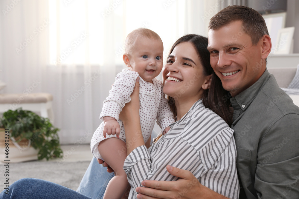 Happy family with their cute baby in living room at home Happy family with their cute baby in living room at home