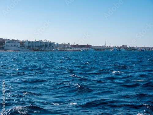 Beautiful view of hotels on the seashore against the backdrop of sea waves. © Konstantin divelook