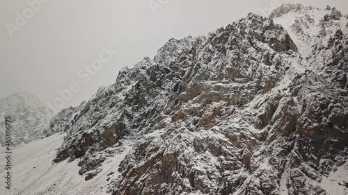 Storm, snowfall in the huge glacier of Mount Belukha, the valley of the Aktru River, the Altai Mountains. Cloudy weather, stone in the snow, storm, wildlife, winter forest, frozen mountain river in