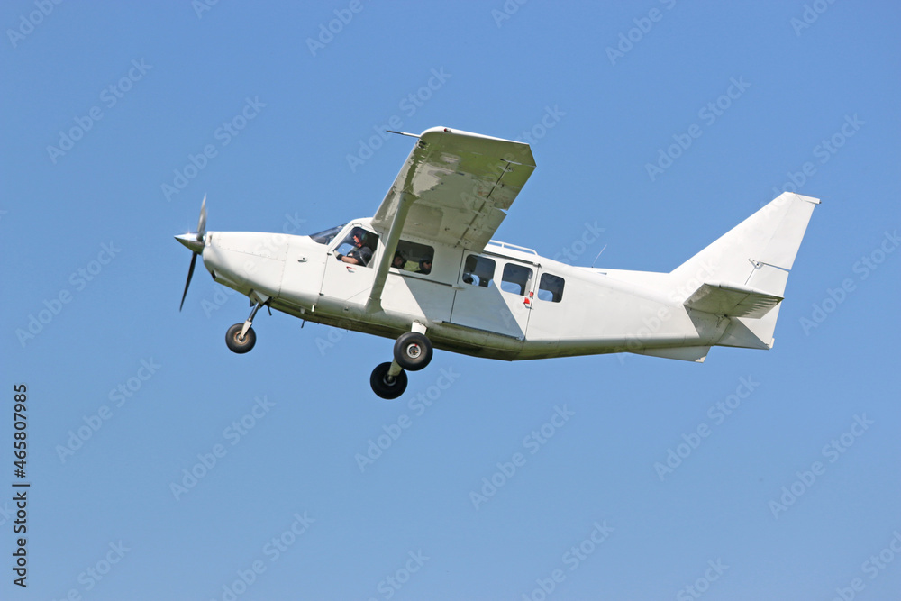 Ultralight airplane flying in a blue sky
Ultralight airplane flying in a blue sky