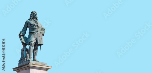 Monument of famous German composer George Frideric Handel in Halle (Saale) Marktplatz, Germany, at blue sky solid background with copy space. Concept of historical architecture heritage.