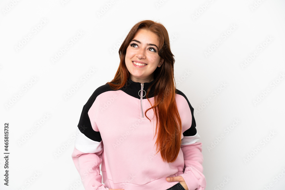 Young redhead woman isolated on white background thinking an idea while looking up Young redhead woman isolated on white background thinking an idea while looking up
