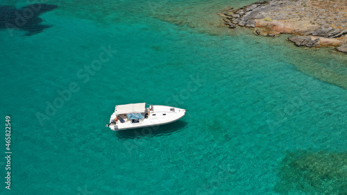 Aerial drone photo of inflatable boat anchored in tropical Caribbean turquoise bay with calm sea © aerial-drone