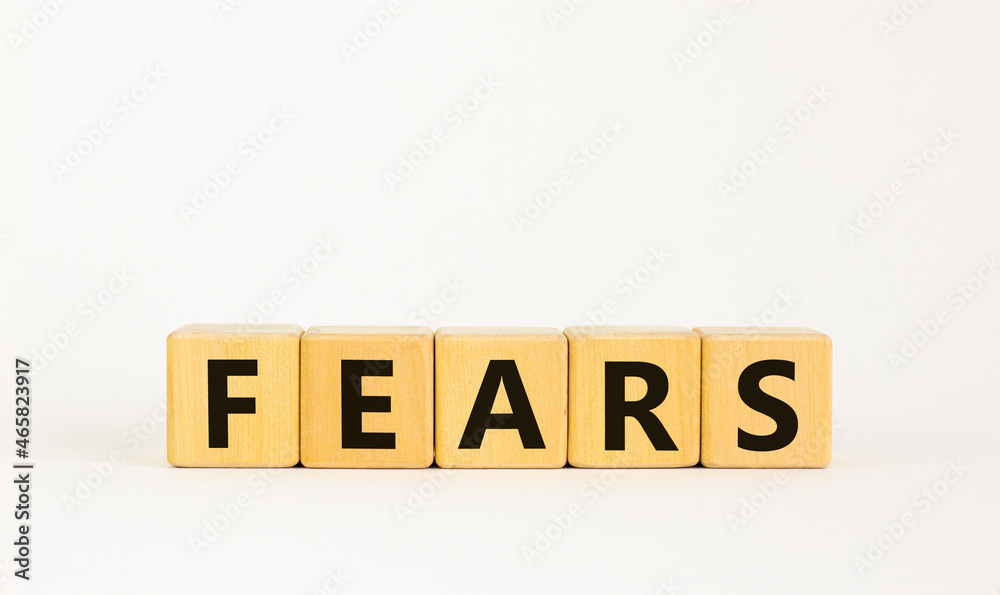 Fears symbol. The concept word 'fears' on wooden cubes. Beautiful white table, white background, copy space. Business, psychological and fears fear concept. Fears symbol. The concept word 'fears' on wooden cubes. Beautiful white table, white background, copy space. Business, psychological and fears fear concept.