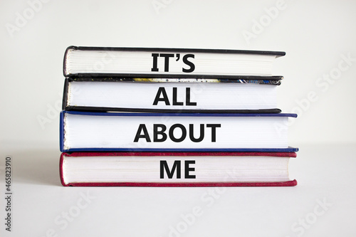 It is all about me symbol. Books with words 'It is all about me'. Beautiful white background. Businessman hand. Copy space. Business and it is all about me concept.