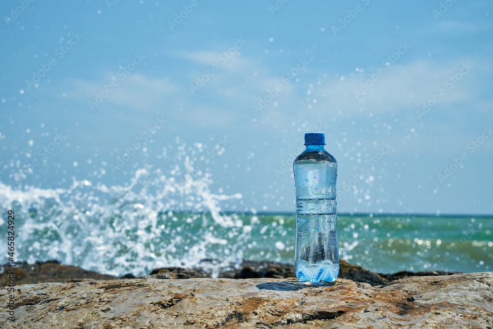 Plastic bottle. Coast of the sea. Waves hit the stones. Plastic bottle. Coast of the sea. Waves hit the stones.