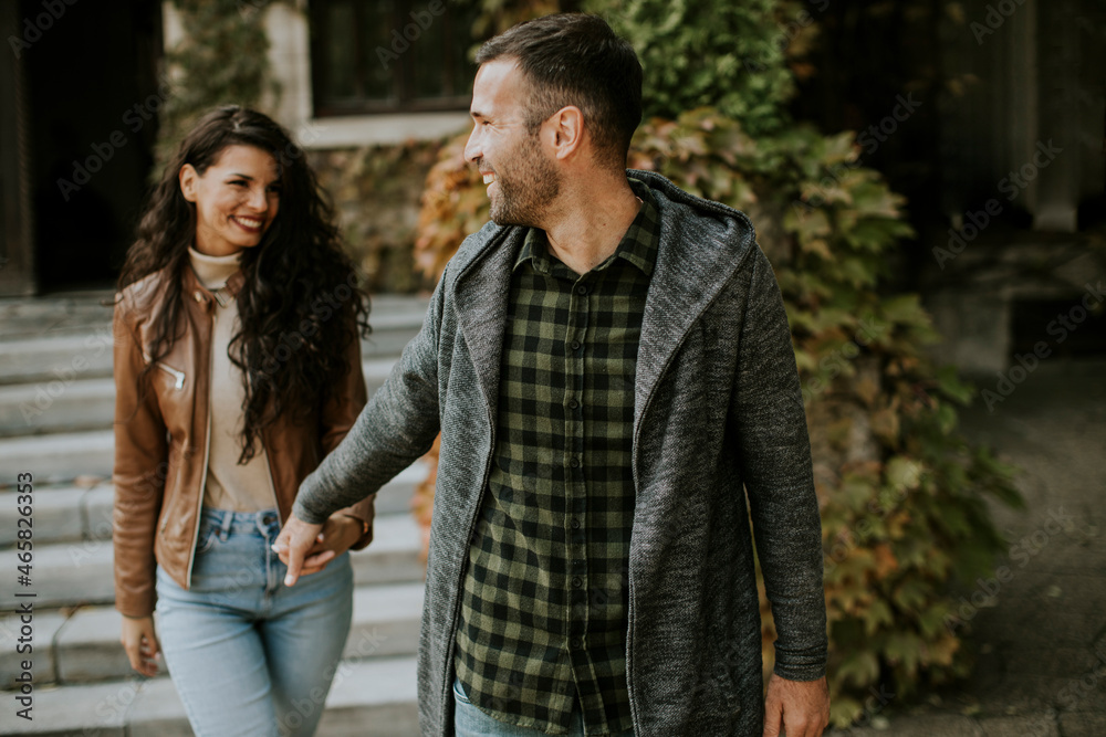 Fototapeta premium Young couple walking in autumn park