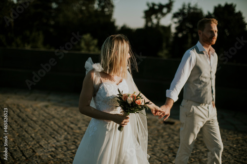 Young newlywed couple walki...