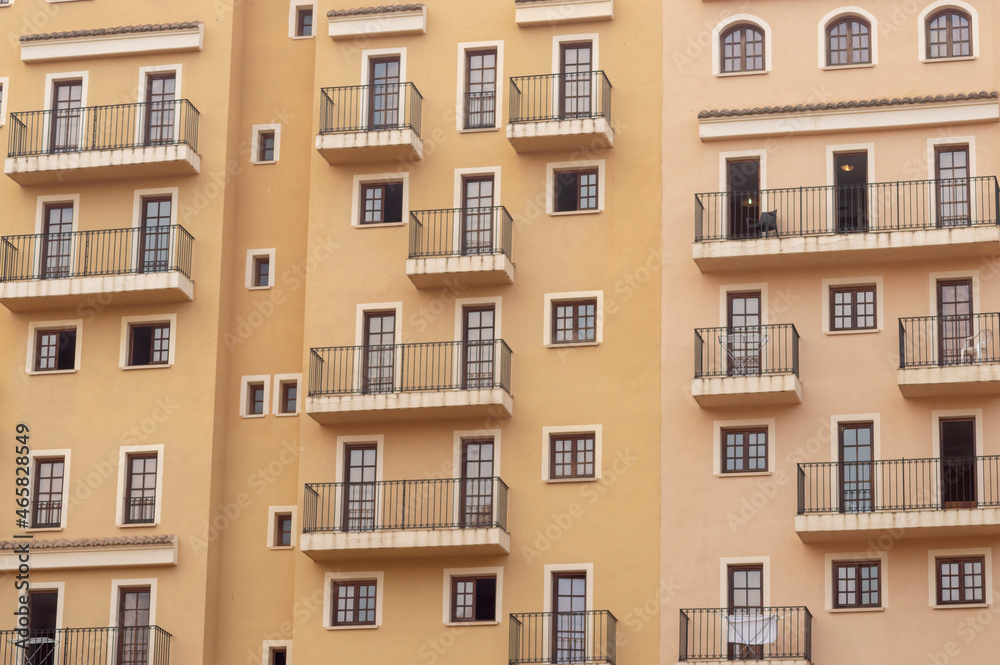 facade of a community with multiple balconies and windows of different sizes