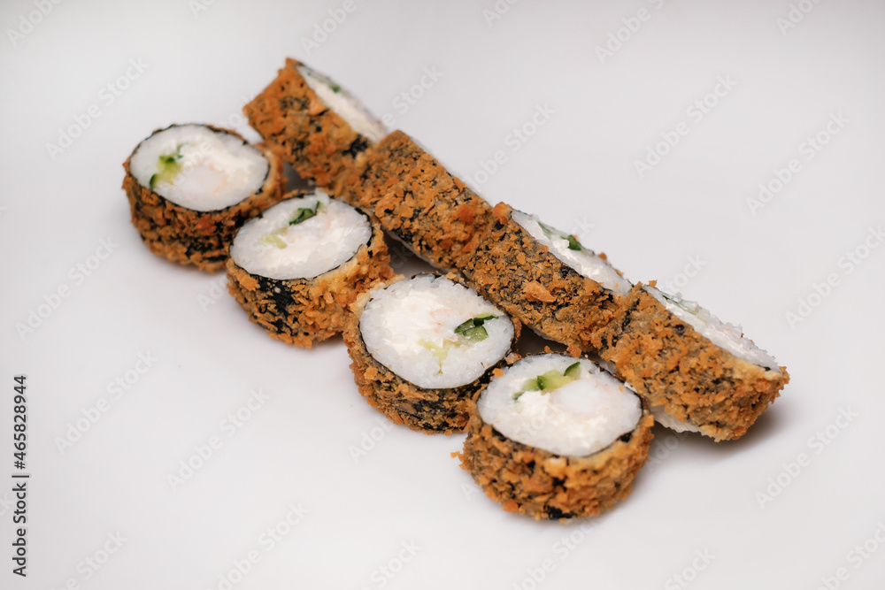 Sushi set with salmon, tuna and cream cheese close-up. Traditional Japanese cuisine on white background. Sushi set with salmon, tuna and cream cheese close-up. Traditional Japanese cuisine on white background.