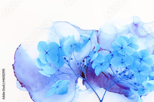 Creative image of blue Hydrangea flowers on artistic ink background. Top view with copy space