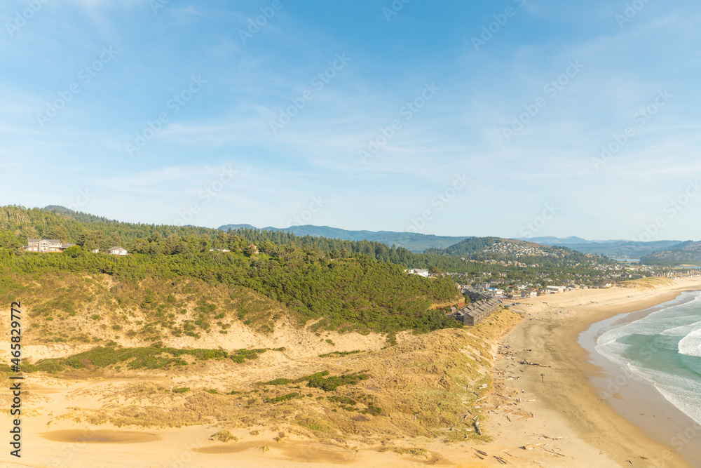 Wild deserted ocean shore. Sandy hills. Strip of the ocean, blue sky. Sparse vegetation. There is no one in the photo. Calm scenes. Tourist destinations, postcard, advertising. Wild deserted ocean shore. Sandy hills. Strip of the ocean, blue sky. Sparse vegetation. There is no one in the photo. Calm scenes. Tourist destinations, postcard, advertising.