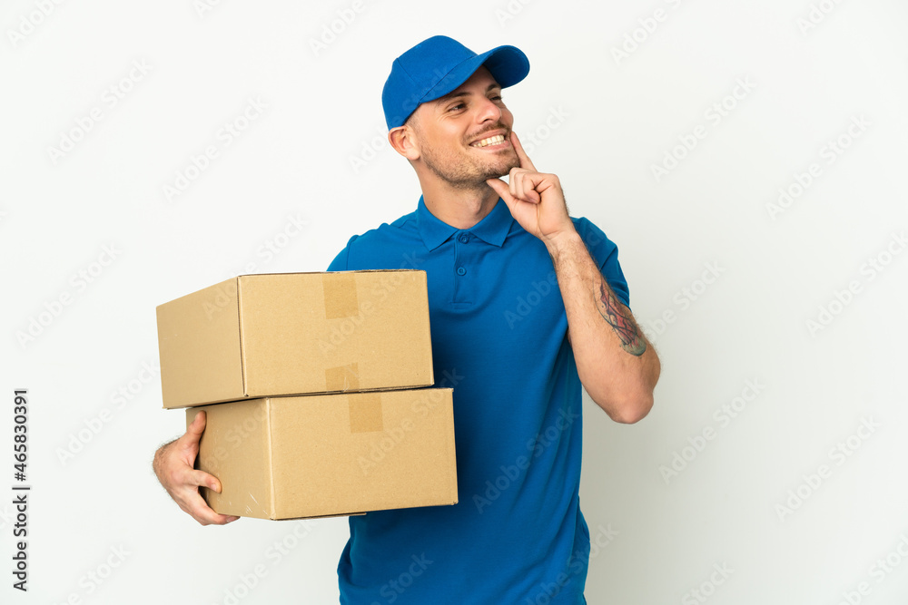 Delivery caucasian man isolated on white background thinking an idea while looking up Delivery caucasian man isolated on white background thinking an idea while looking up