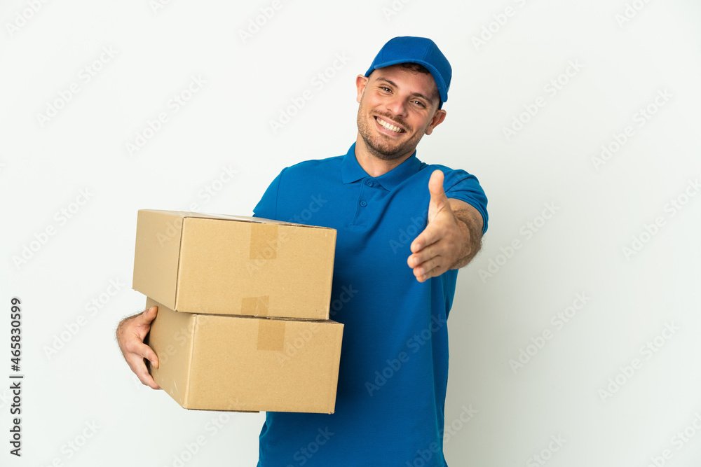 Delivery caucasian man isolated on white background shaking hands for closing a good deal Delivery caucasian man isolated on white background shaking hands for closing a good deal