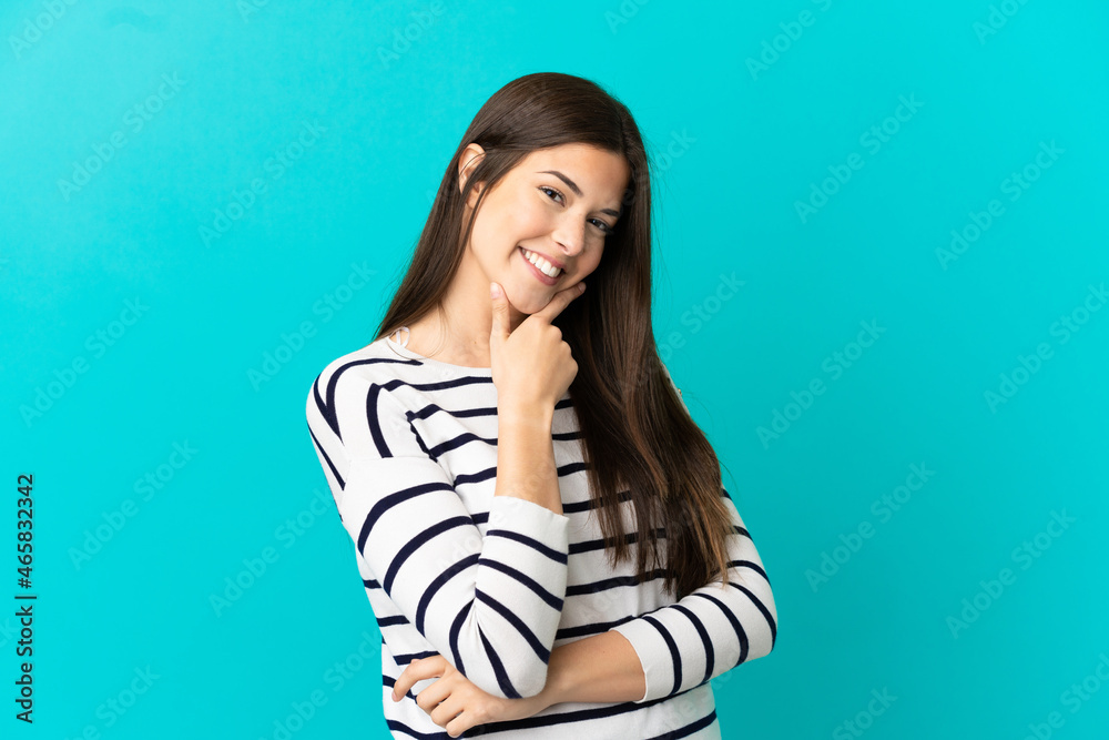 Teenager Brazilian girl over isolated blue background happy and smiling Teenager Brazilian girl over isolated blue background happy and smiling
