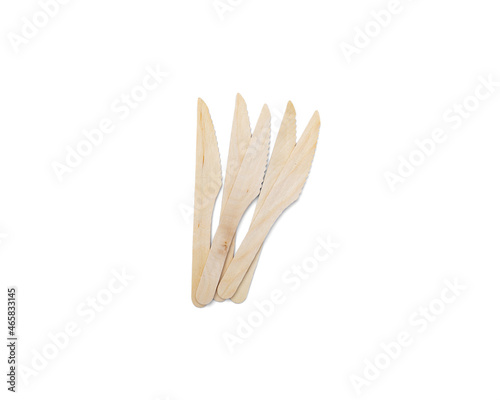 Eco-friendly wooden disposable cutlery. Many knives on a white background