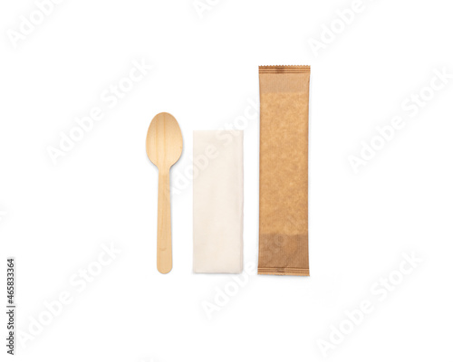 Eco-friendly wooden disposable cutlery. Fork, spoon and napkin in a craft envelope on a white background.