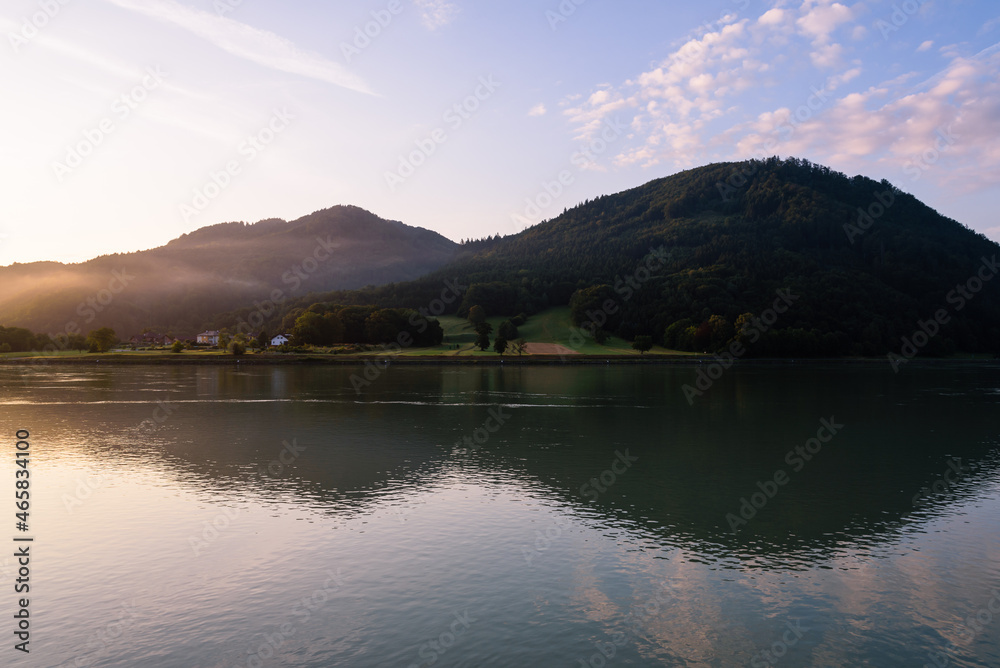 Scenic view of beautiful mountains with fog along the Danube river at sunrise, Grein, Austria